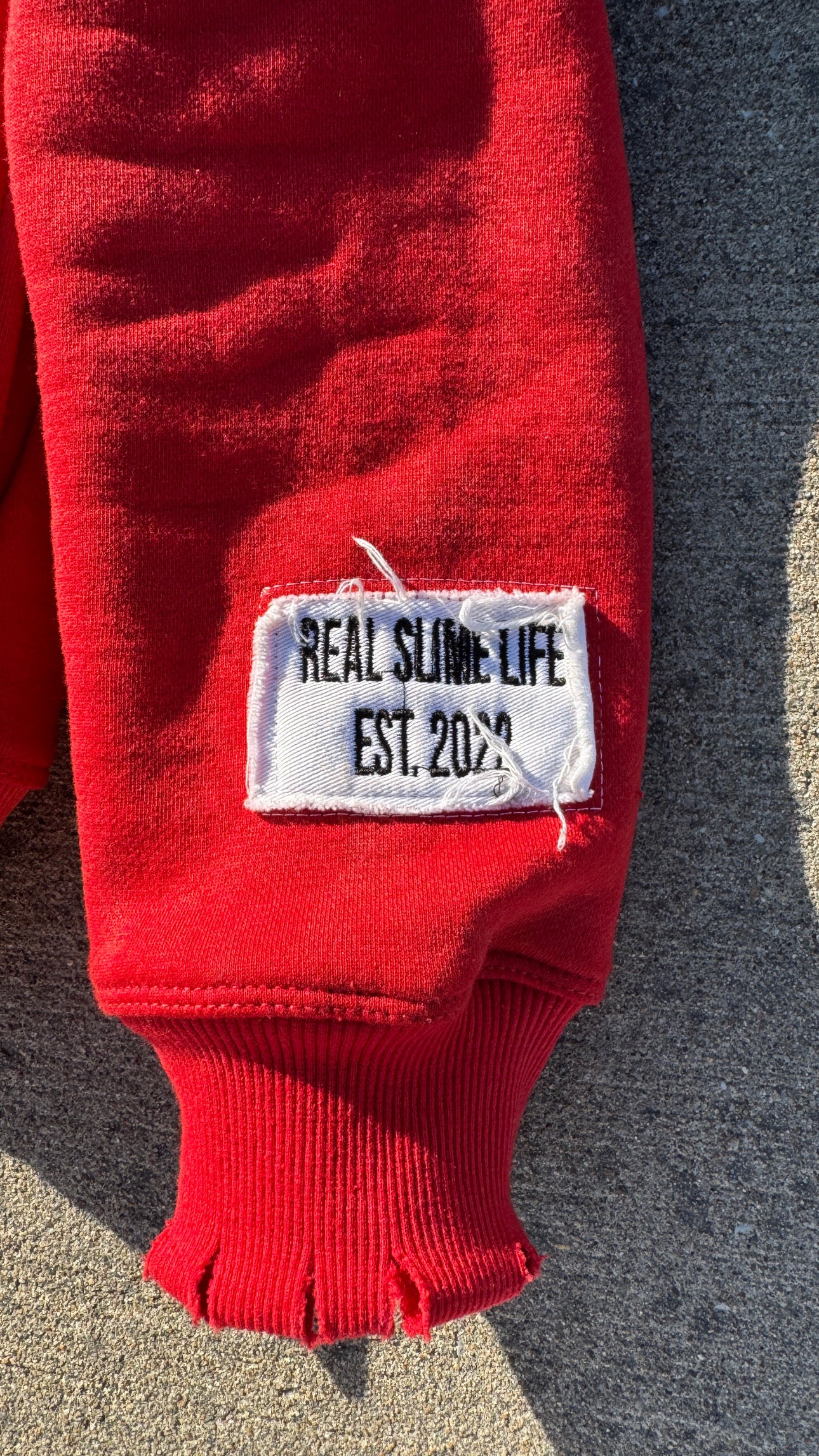Red “Members Only” zip-up